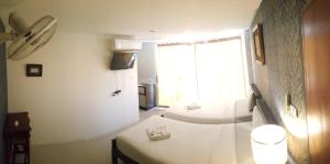 a white room with two beds and a window at Chatchada House in Ao Nang Beach