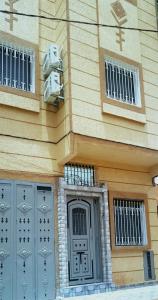 a building with two windows and a door at Dar Yan in Er Rachidia