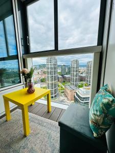 a yellow table in a room with a view of a city at Apartments in Panorama City on 25th floor - amazing view close to Old town in Bratislava