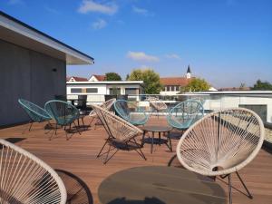 a group of chairs and tables on a deck at Hotel Nachtquartier in Weil der Stadt