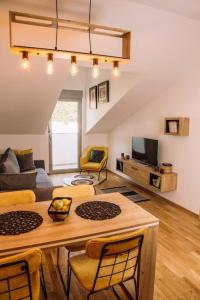 a living room with a table and a couch at MT One-bedroom boho apartment, Budva in Budva