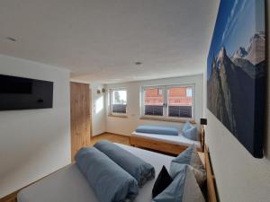 a bedroom with a bed and a tv and a couch at Apart Kreuzspitz in Vent