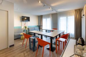 a living room with a dining table and chairs at ibis Budget Millau Viaduc in Millau +93 photos