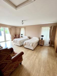 a large bedroom with two beds and a couch at Bridie's Place in Ballycastle