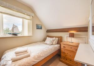 a small bedroom with a bed and a window at Apple Barn in Fylingdales