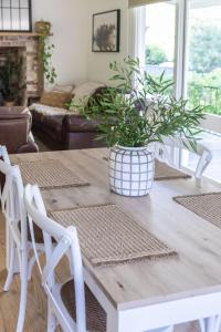 a dining room table with a potted plant on it at Myrtle Creek Cottage in Myrtleford