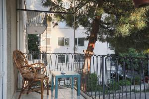 a table and chairs on a porch with a tree at on the street of Bagdat in Istanbul