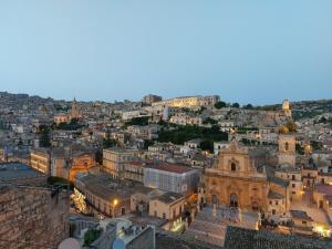 an aerial view of a city at night at Mimma holiday house in Modica