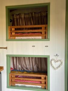 a hutch with a bed in a room at Dune Shepherds Hut in Penally