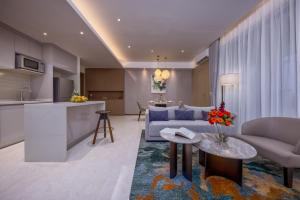 a living room with a couch and a table and a kitchen at Pan Pacific Serviced Suites Nairobi in Nairobi +49 photos
