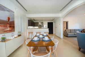 a kitchen and living room with a table and chairs at Key View - District 8A Villa JVT in Dubai