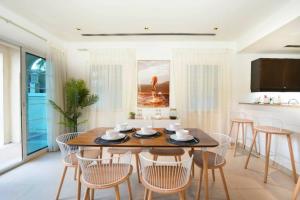 a dining room with a table and chairs at Key View - District 8A Villa JVT in Dubai