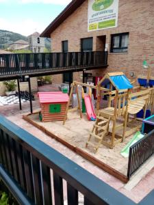 a playground with play equipment on a balcony at Apartahotel Rural CollaRubio Luxury in Collado Mediano