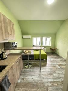 a kitchen with a table in the middle of a room at Central Park Apartment on Sumskaya in Kharkiv