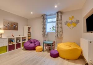 a kids room with a yellow and purple ottoman at Blacksmiths Cottage in Catterick Bridge