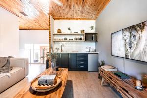 a living room with a couch and a table at Feather Nest Guest House in Oudtshoorn