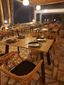 a dining room with tables and chairs and lights at Aegean Pearl in Tigaki