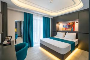A bed or beds in a room at Gümüş Yazar Hotel