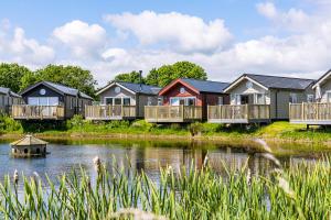 a row of houses next to a body of water at The Bay Filey in Filey