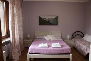 a bedroom with a bed with two towels on it at Bed And Breakfast Del Lago in Avigliana