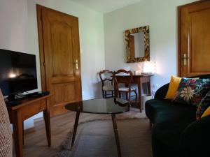 a living room with a couch and a table at La Maison Fleurie in Dieffenbach-au-Val