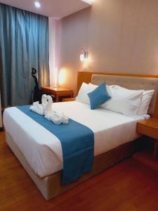 a bedroom with a bed with a stuffed animal on it at Z Addis Hotel in Addis Ababa