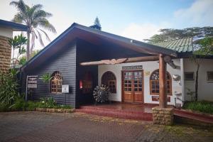a small black and white building with a door at Aero Club of East Africa in Nairobi