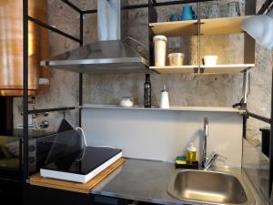 a kitchen with a sink and a counter top at Framer's House - Authentic Downtown in Porto