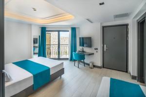 A bed or beds in a room at Gümüş Yazar Hotel