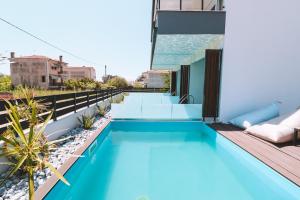 a swimming pool on the roof of a building at Sithon Diamond Suites 1 in Nikiti