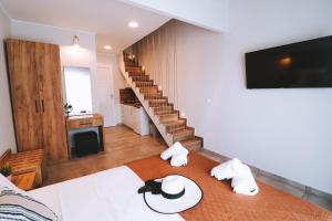a room with a bed with towels on a table at Sithon Diamond Suites 1 in Nikiti