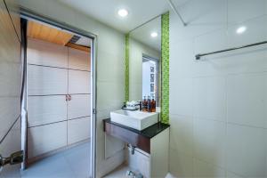 a bathroom with a sink and a shower at The Legacy Hotel in Nonthaburi