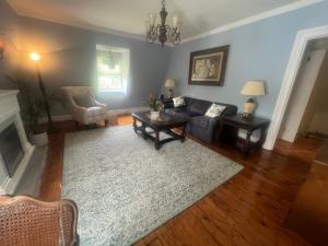 a living room with a couch and a table at Private Victorian Apartment in convenient City location on 5 acre, Sleeps 5 in Poughkeepsie