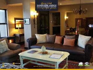 a living room with a couch and a coffee table at Sandton Lodge Rivonia in Johannesburg