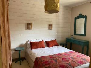 1 dormitorio con cama, mesa y espejo en l'Océane, en Lège-Cap-Ferret