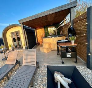 a patio with two chairs and a table at New Farm Cheshire Holidays in Winsford