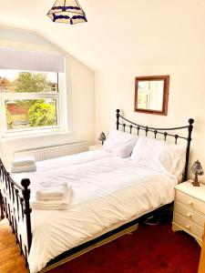 1 cama blanca grande en un dormitorio con ventana en Vista Do Mar - Cowes, en Cowes