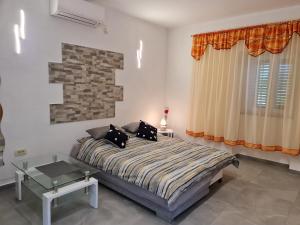 a bedroom with a bed with two pillows on it at Studio Apartman D&D in Brseč