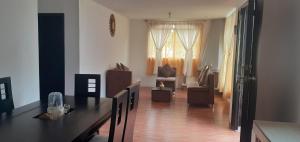 a living room with a dining table and a living room at Casa campestre en las faldas del Taita Imbabura in San Juan de Ilumán