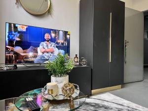 sala de estar con TV y mesa de cristal en Matcha themed Apartment in City, en Johannesburgo