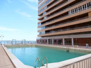 a large swimming pool in front of a building at Esmeralda Beach in Torrevieja