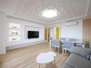 a living room with a couch and a table and chairs at Esmeralda Beach in Torrevieja