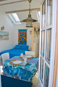 a dining room with a blue table and a window at Casa Mediterraneo Perast in Perast