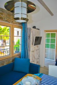 a living room with a blue couch and a table at Casa Mediterraneo Perast in Perast