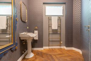 a bathroom with a sink and a mirror at Duomo Smart Suites in Milan +288 photos