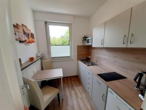 a small kitchen with a table and a window at FeWo Greiwe in Telgte