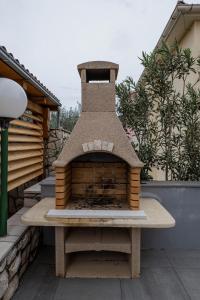 a brick oven sitting on top of a bench at Apartment Dubravka in Povljana