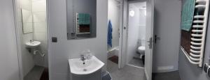 ワルシャワにあるHostel POPLAWOKの白いバスルーム(洗面台、トイレ付)
