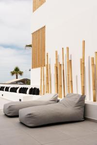 a room with two beds and a wall with wooden poles at Petradi Beach Lounge Hotel in Rethymno