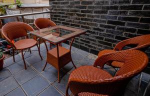 a group of chairs and a glass table on a patio at Satkar Hotel and Spa in Kathmandu